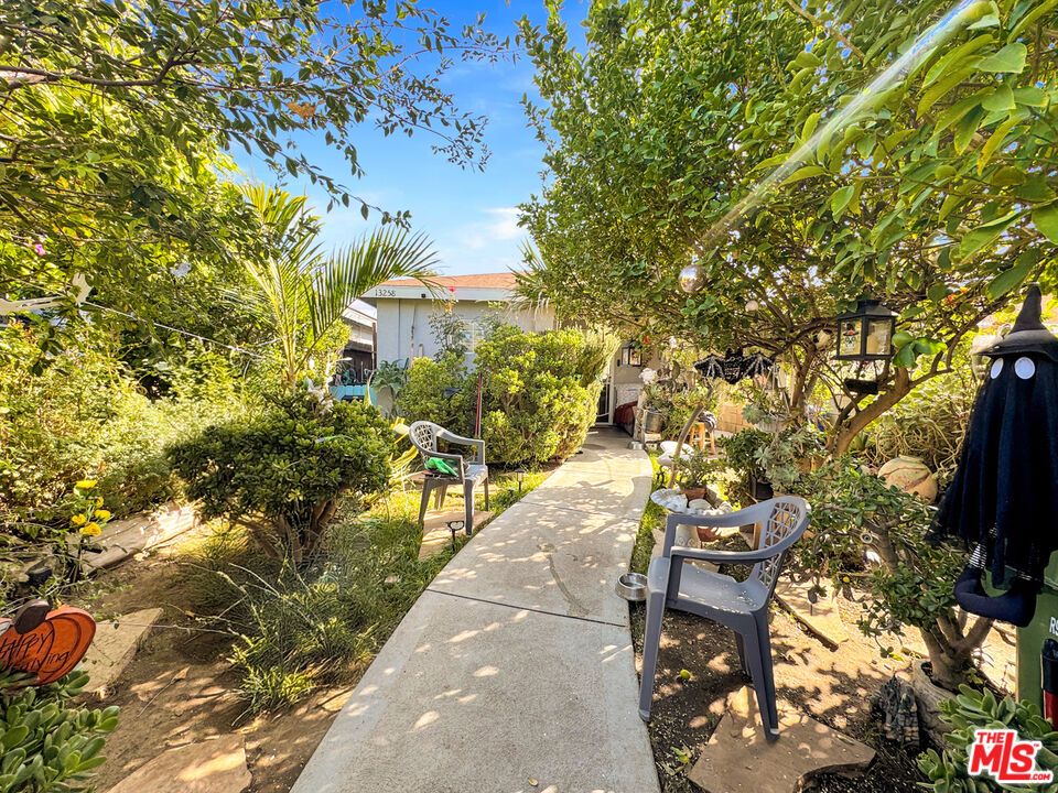 13258 Filmore Street Pacoima, CA 91331 - Photo 20 of 30 a view of a patio with table and chairs and potted plants