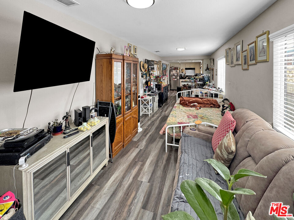 13258 Filmore Street Pacoima, CA 91331 - Photo 3 of 30 a living room with furniture and a flat screen tv