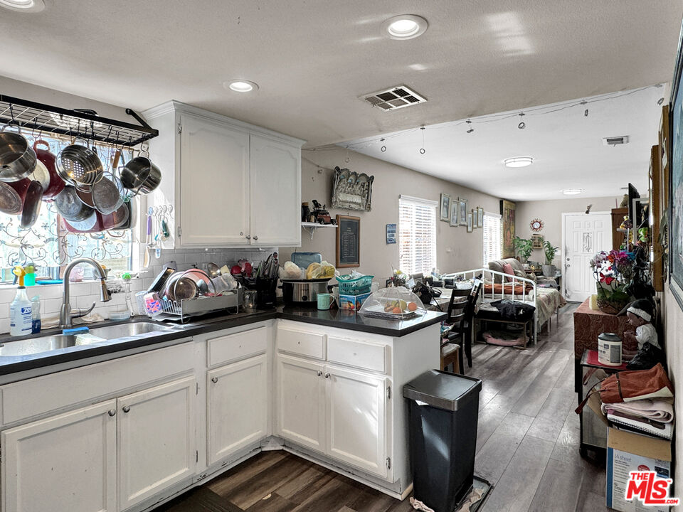 13258 Filmore Street Pacoima, CA 91331 - Photo 4 of 30 a kitchen with a sink stove and cabinets
