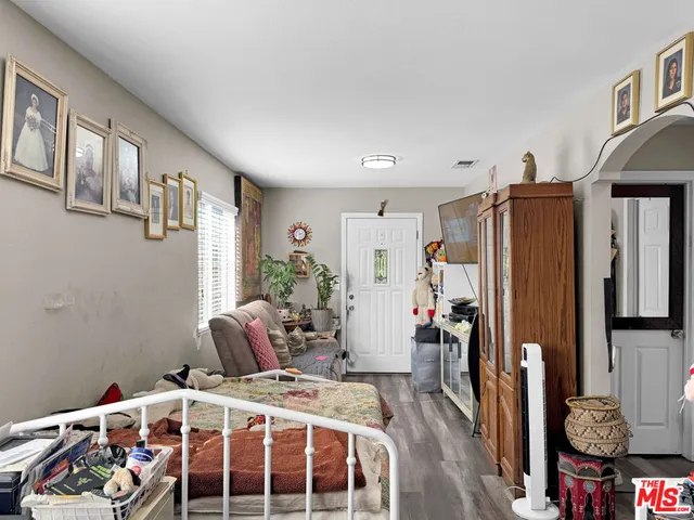 a bedroom with a bed closet and a window