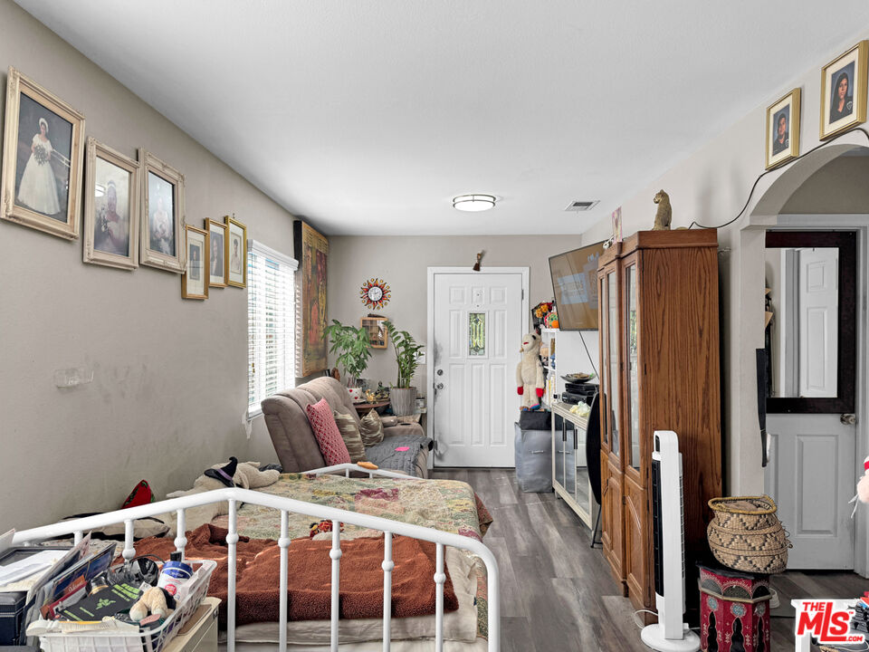 13258 Filmore Street Pacoima, CA 91331 - Photo 6 of 30 a bedroom with a bed closet and a window