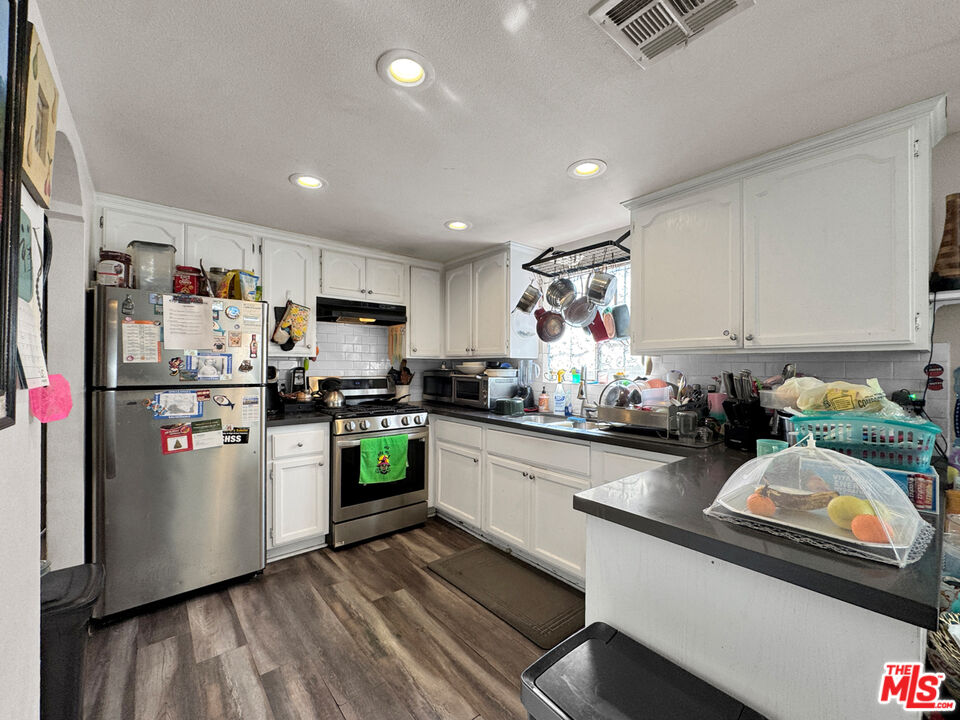 13258 Filmore Street Pacoima, CA 91331 - Photo 8 of 30 a kitchen with refrigerator and cabinets