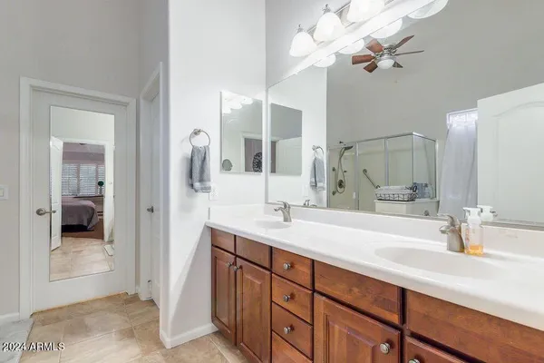 a bathroom with a sink double vanity granite and a mirror