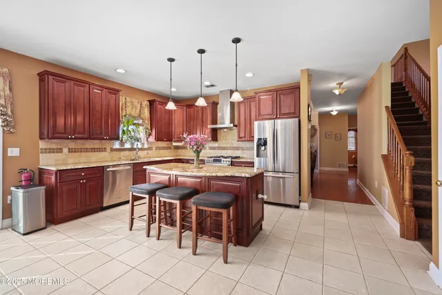a bathroom with a granite countertop toilet sink and mirror