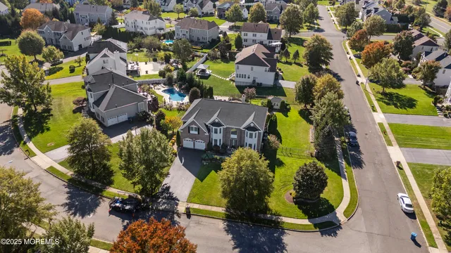 an aerial view of residential house with outdoor space and swimming pool