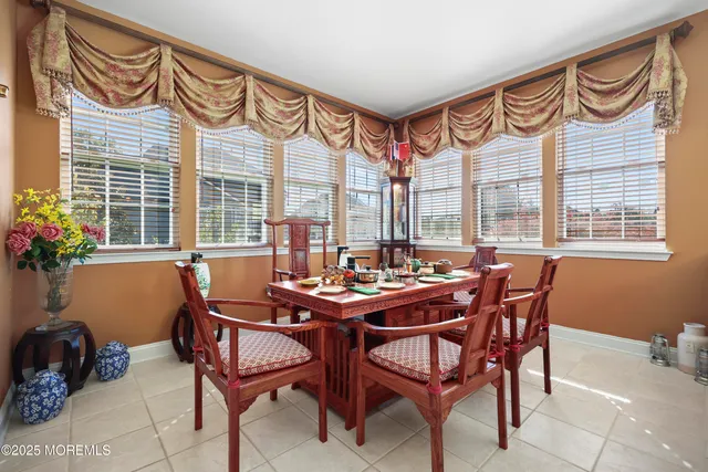 a living room with furniture and a painting on the wall