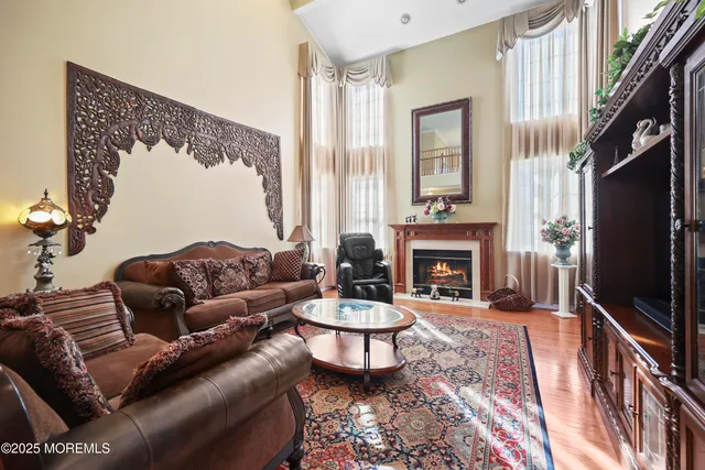 a living room with a bed furniture and a ceiling fan