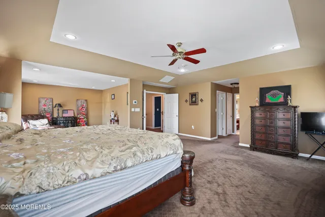 a spacious bathroom with a large tub sink and mirror