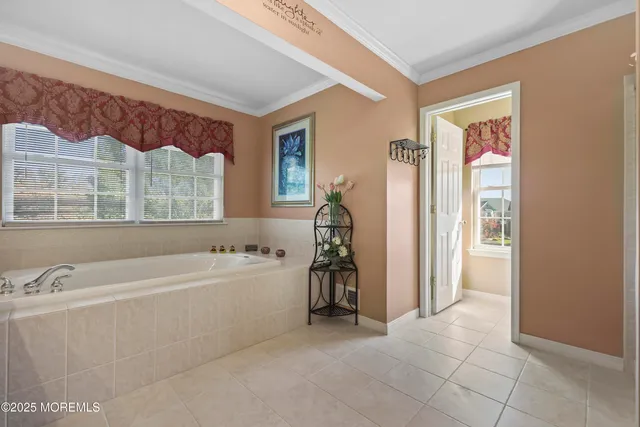 a bedroom with a large bed and a large window