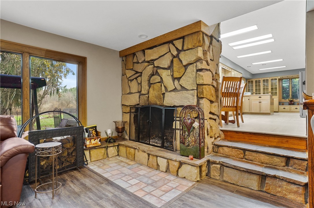 2765 Fixler Road Medina, OH 44256 - Photo 11 of 33 Living room featuring plenty of natural light, wood-type flooring, and a stone fireplace