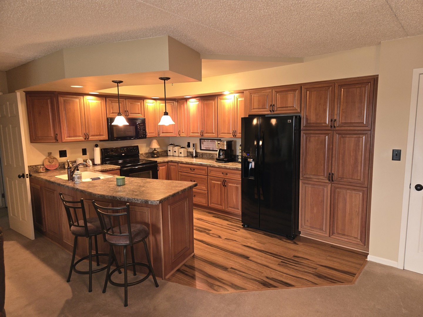 1133 North 7th Street, Unit 802 Rochelle, IL 61068 - Photo 2 of 12 a kitchen with stainless steel appliances granite countertop a refrigerator and a wooden cabinets