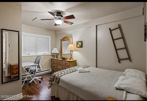 a bedroom with a bed and wooden floor