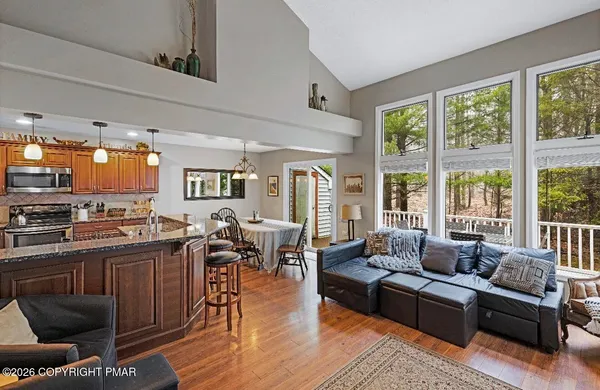 a living room with furniture wooden floor and a large window