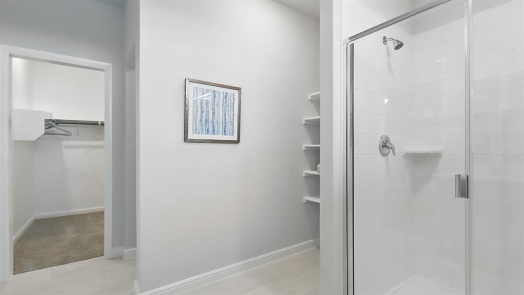 9708 Austin Holw Road Fort Worth, TX 76036 - Photo 21 of 35 a bathroom with a glass shower door