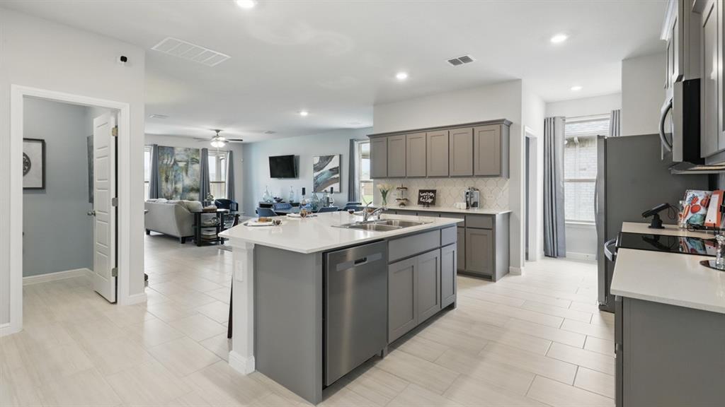 9708 Austin Holw Road Fort Worth, TX 76036 - Photo 5 of 35 a kitchen with stainless steel appliances kitchen island a sink stove and refrigerator