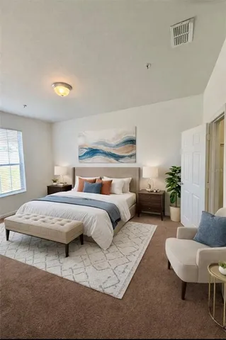 a bedroom with bed and a couch