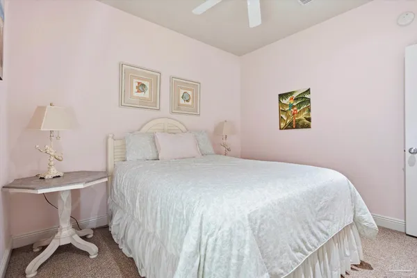 a bedroom with a bed and painting on the wall