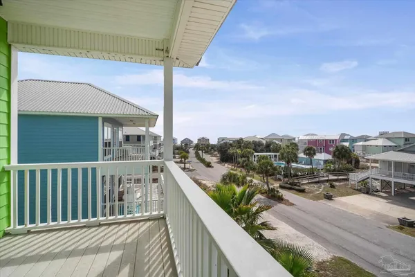 a view of a hallway with wooden floor and a ceiling fan