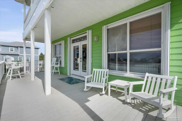 a view of a patio with a table and chairs and a porch