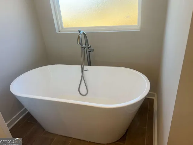 a view of bathroom with granite countertop