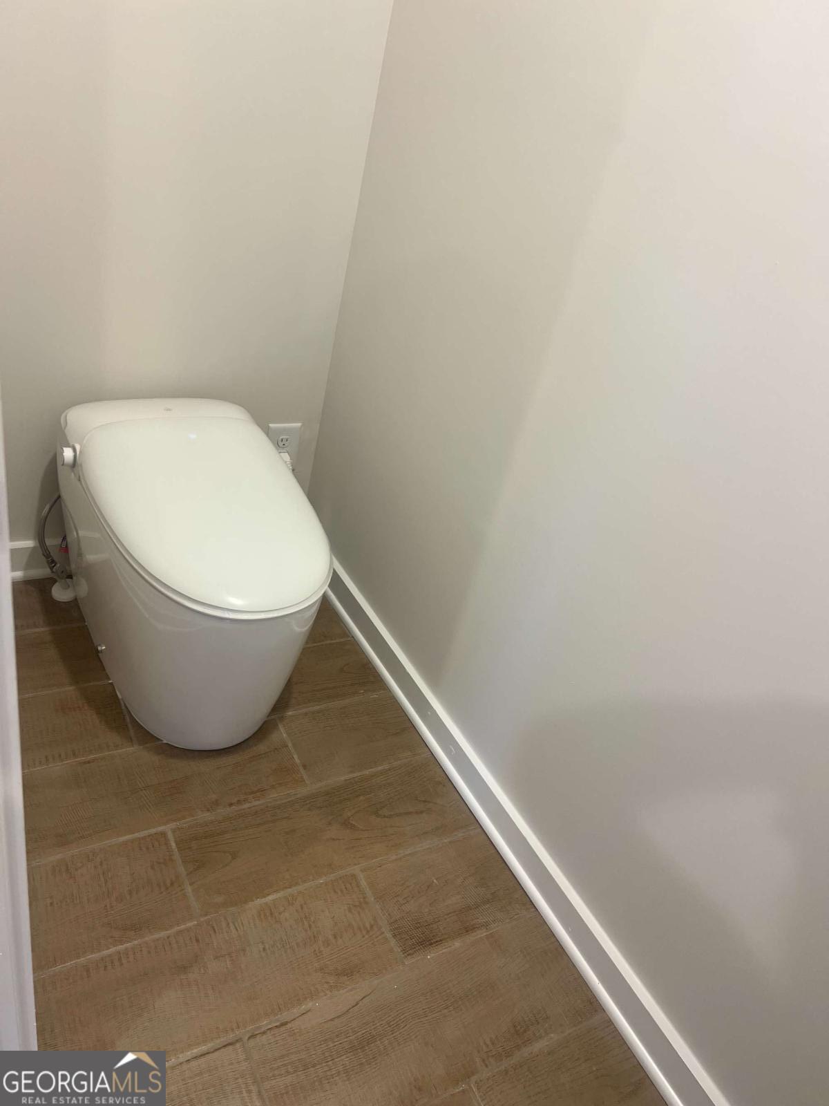 350 Jarrette Street, Unit 54 Fairburn, GA 30213 - Photo 10 of 11 a bathroom with a toilet and a rug