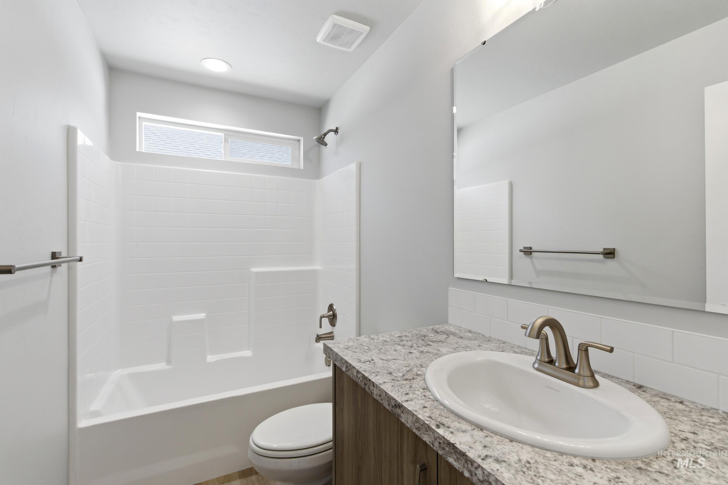 2374 West Fallon Loop Nampa, ID 83651 - Photo 17 of 24 Bathroom featuring a single vanity with a laminate countertop, undermount sink, and brushed nickel faucet