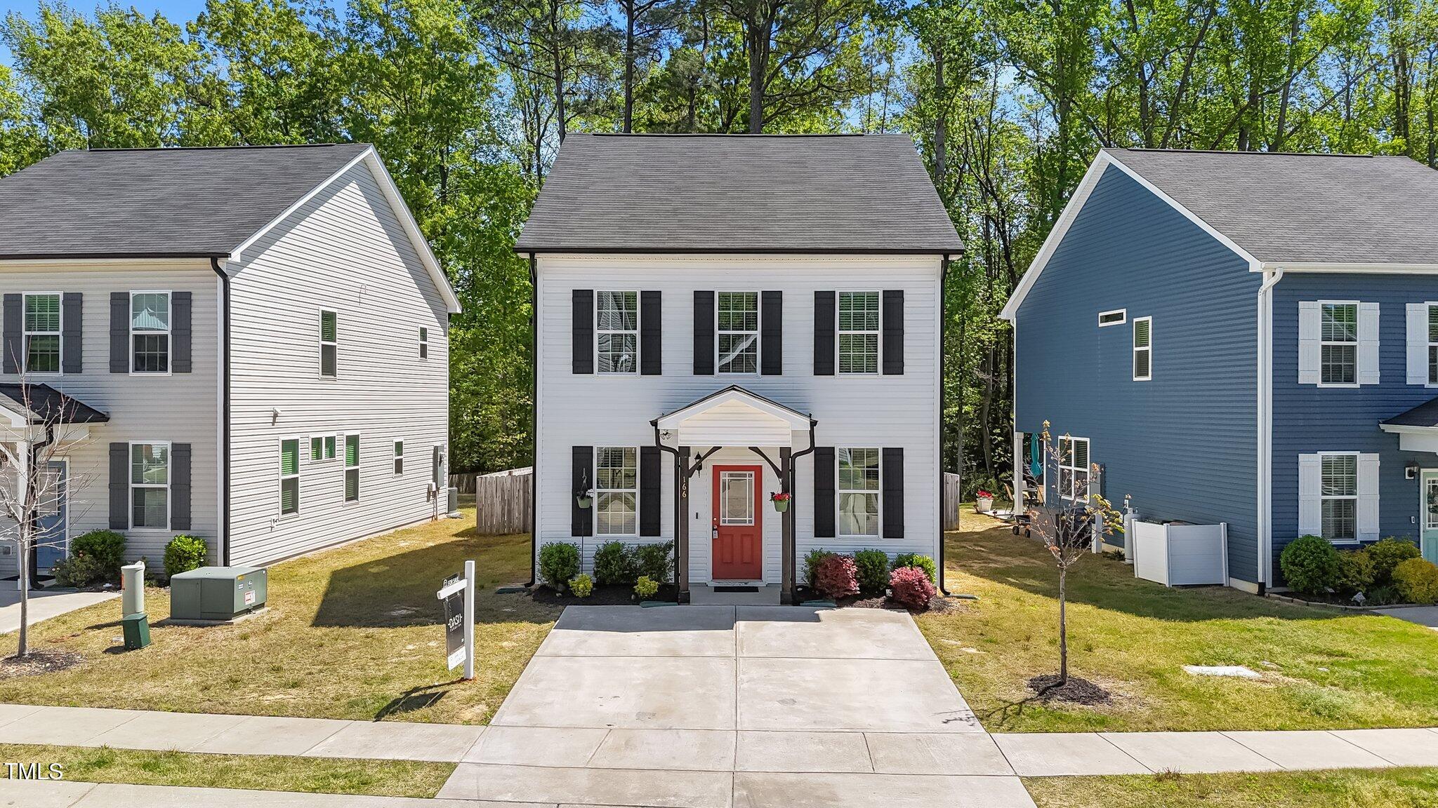166 Yellow Jacket Ridge Clayton, NC 27520 - Photo 1 of 39 a front view of a house with a yard