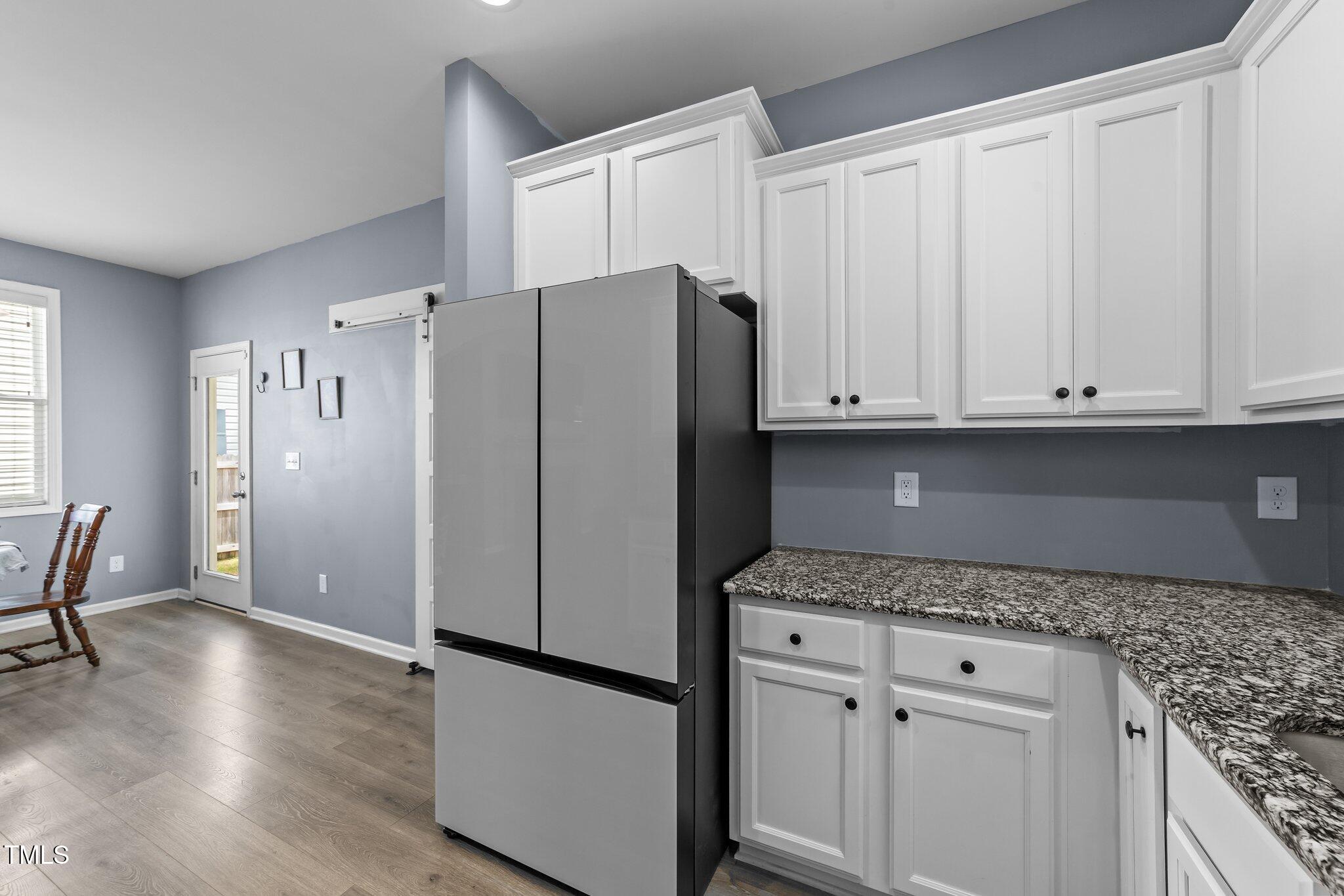 166 Yellow Jacket Ridge Clayton, NC 27520 - Photo 13 of 39 a kitchen with granite countertop white cabinets and refrigerator