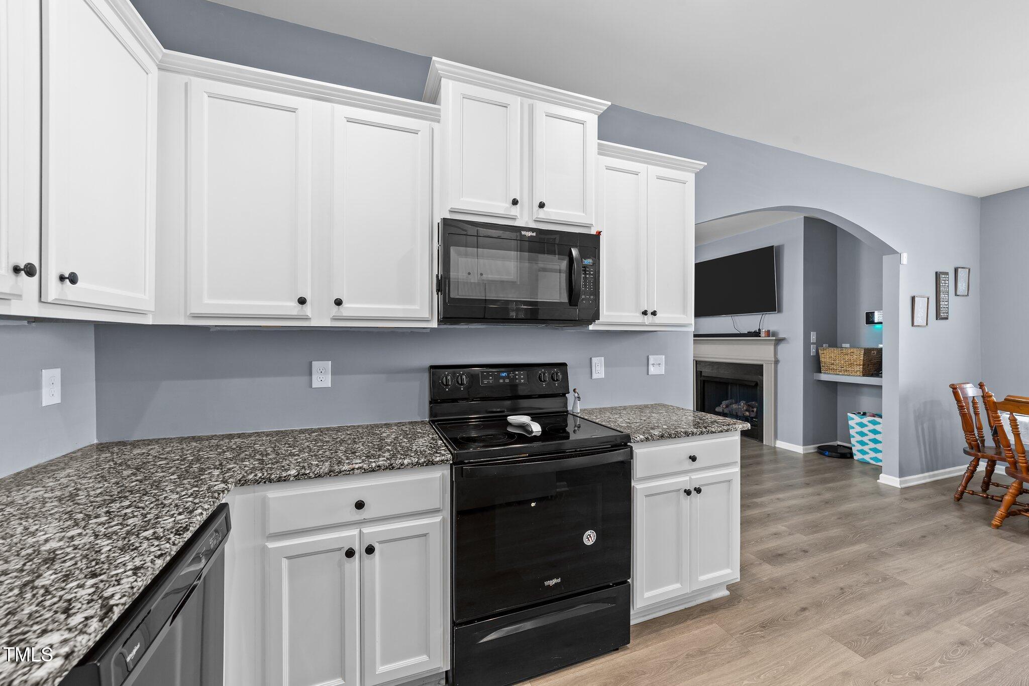 166 Yellow Jacket Ridge Clayton, NC 27520 - Photo 14 of 39 a kitchen with stainless steel appliances granite countertop a stove a sink and a microwave
