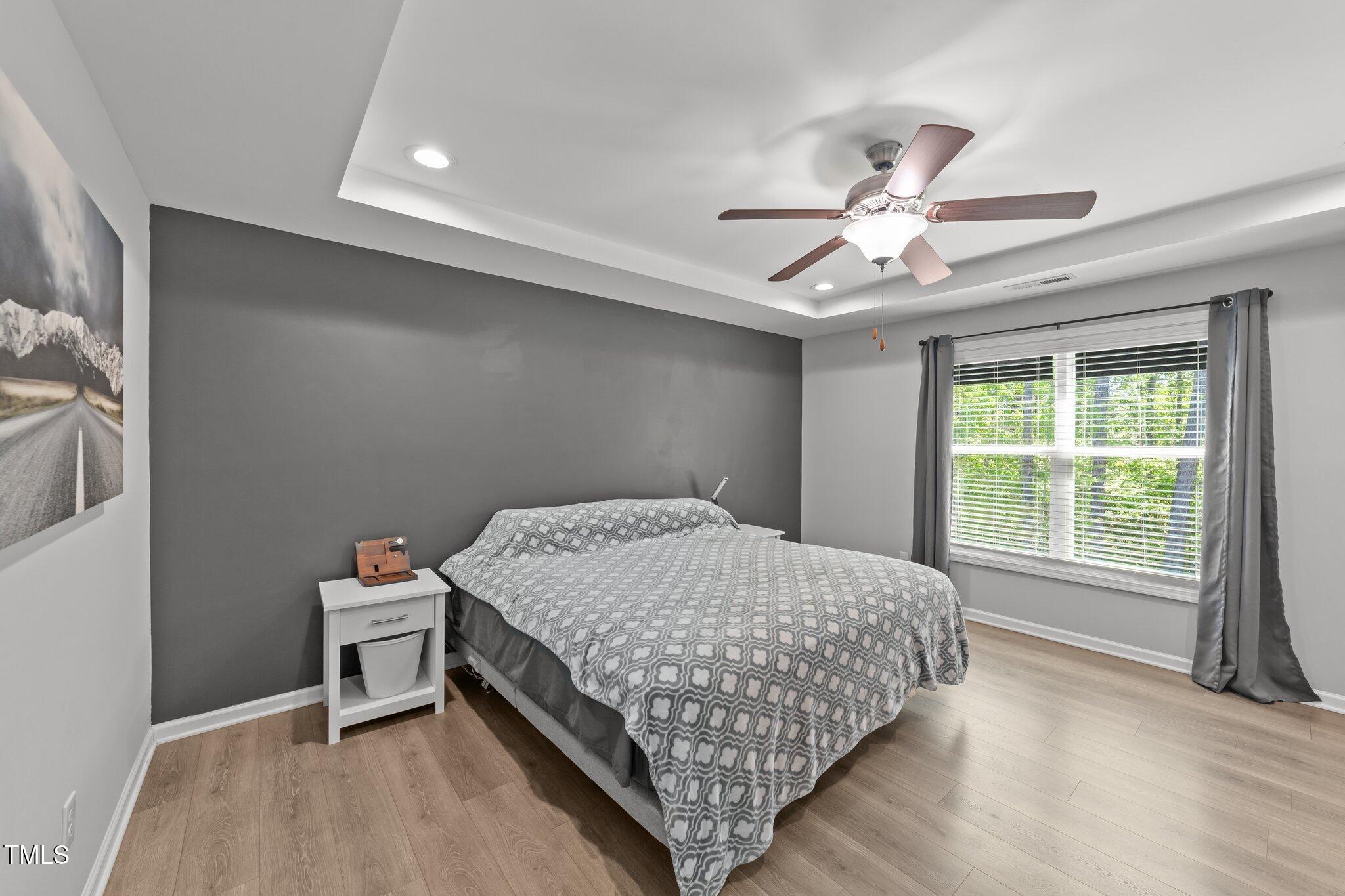 166 Yellow Jacket Ridge Clayton, NC 27520 - Photo 17 of 39 a bedroom with a bed and a chandelier