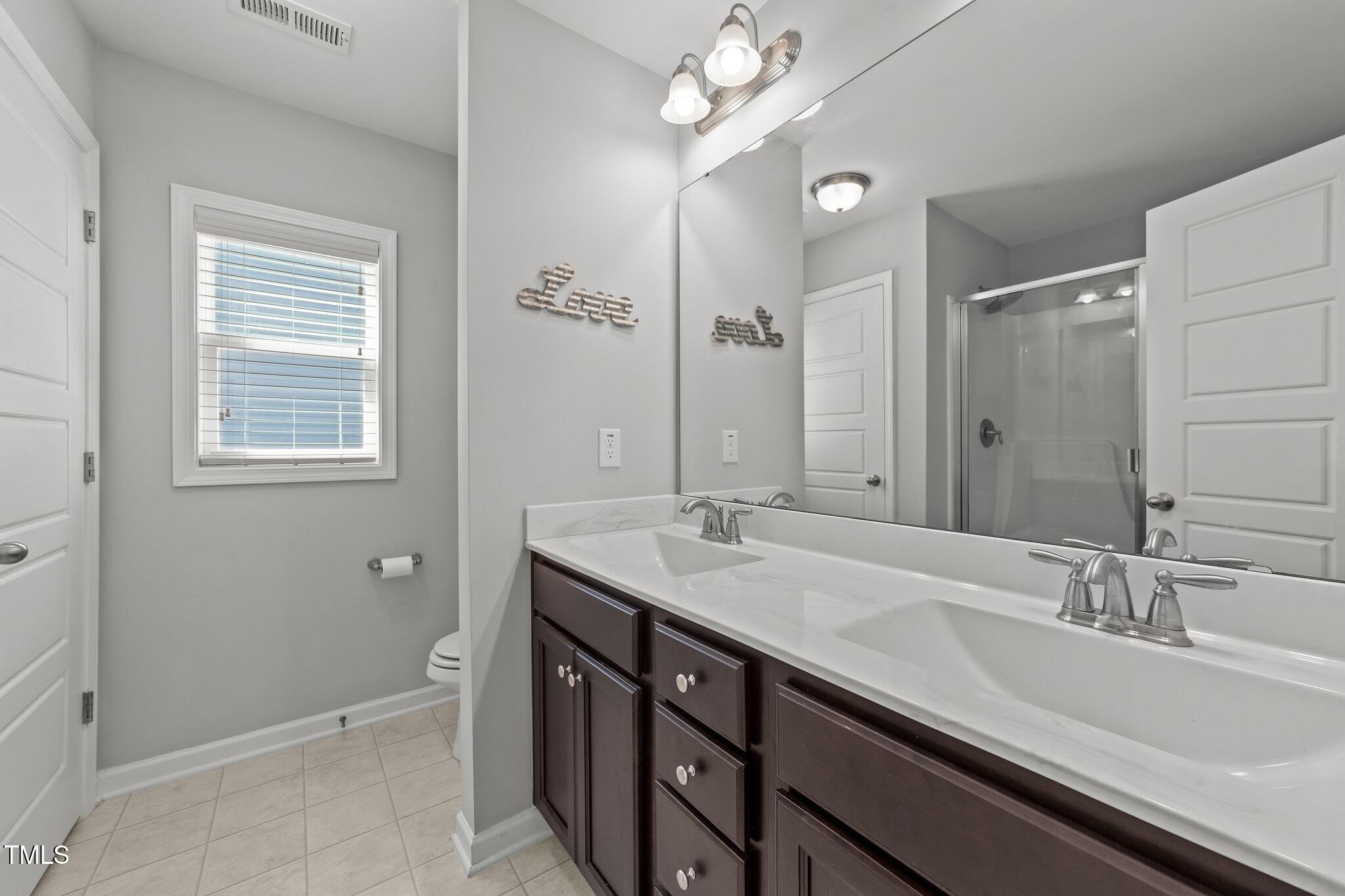 166 Yellow Jacket Ridge Clayton, NC 27520 - Photo 21 of 39 a bathroom with a sink double vanity granite tub and a mirror