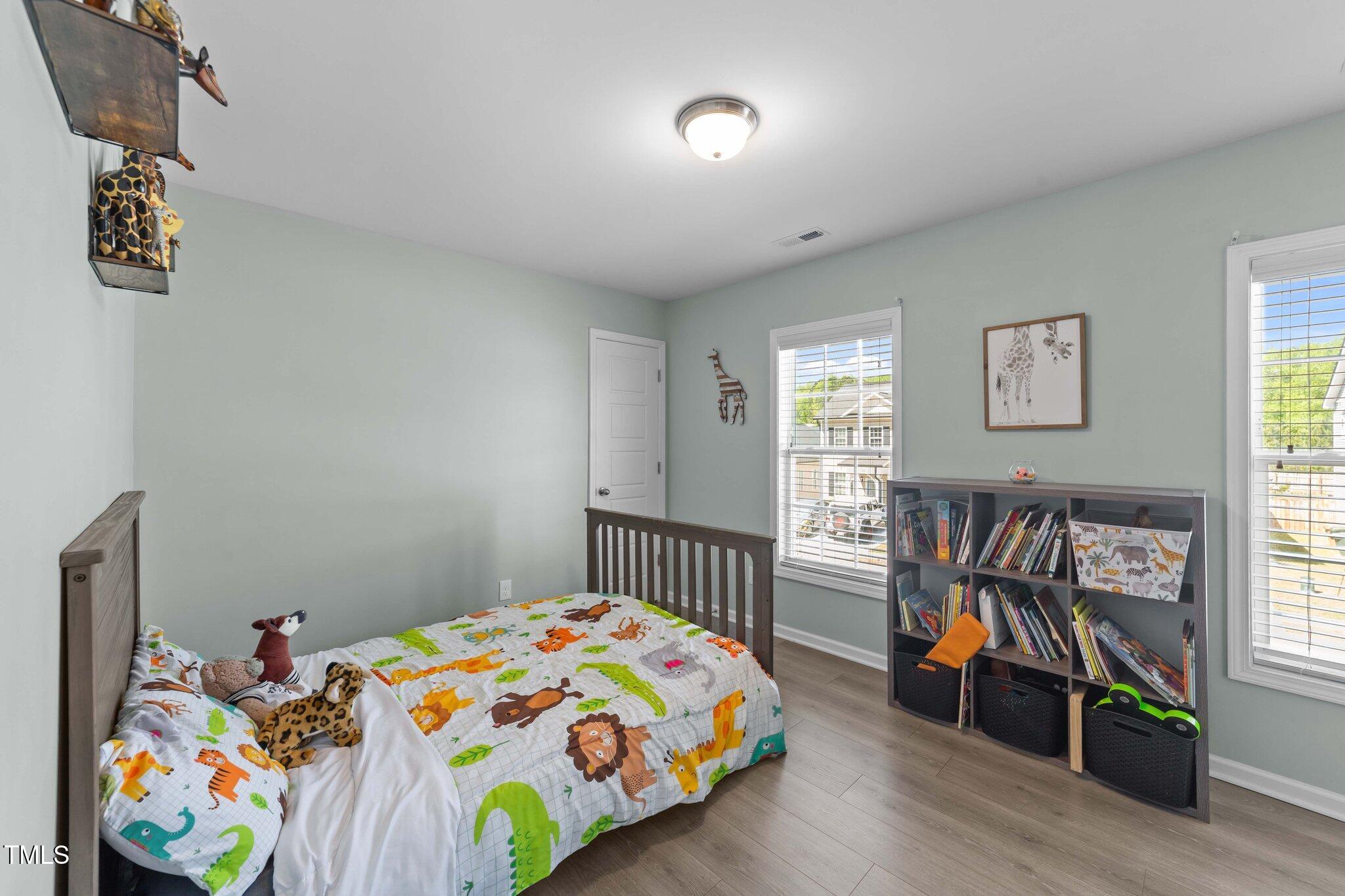 166 Yellow Jacket Ridge Clayton, NC 27520 - Photo 24 of 39 a bedroom with furniture and a window