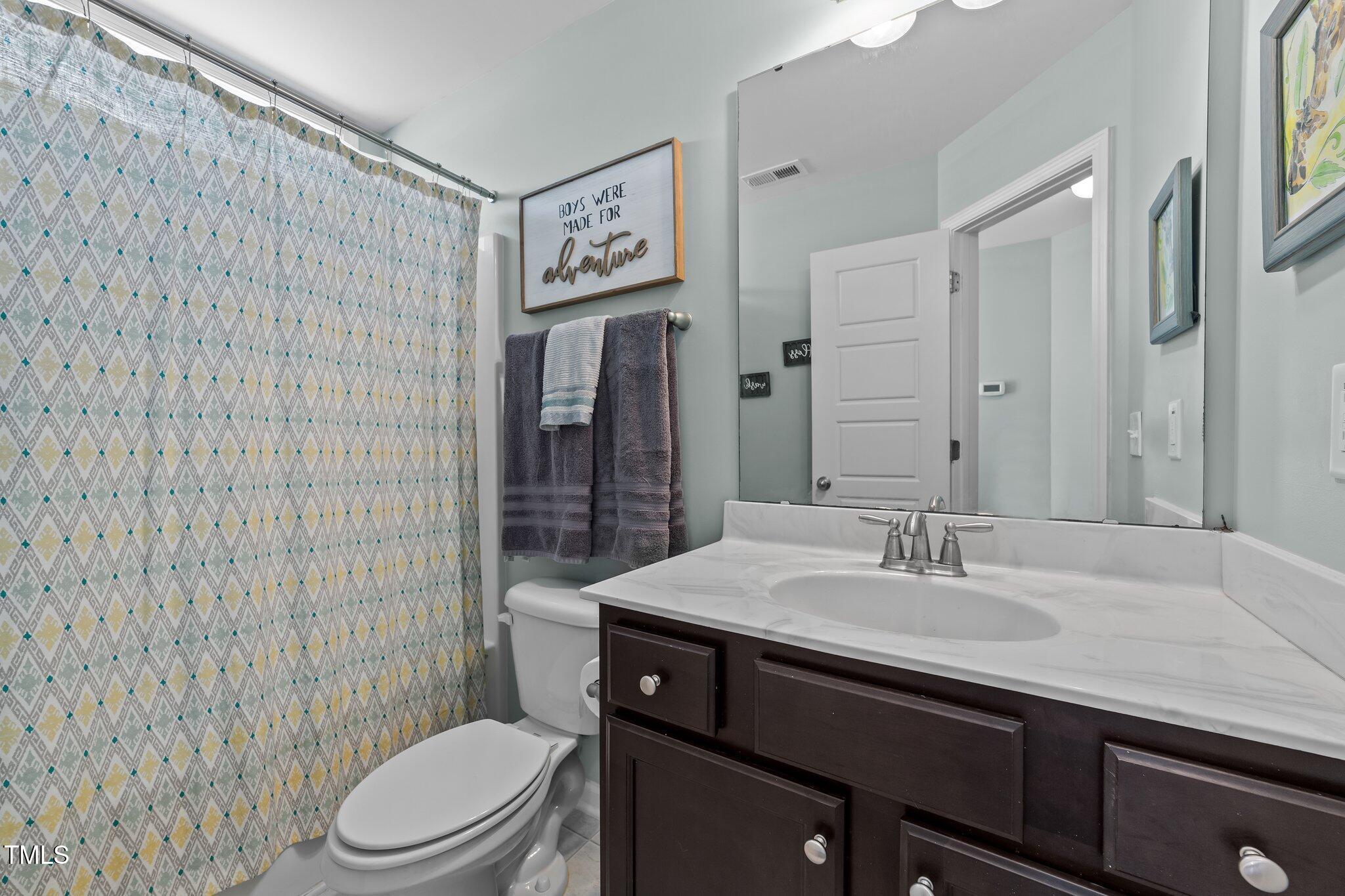 166 Yellow Jacket Ridge Clayton, NC 27520 - Photo 25 of 39 a bathroom with a sink a toilet and shower