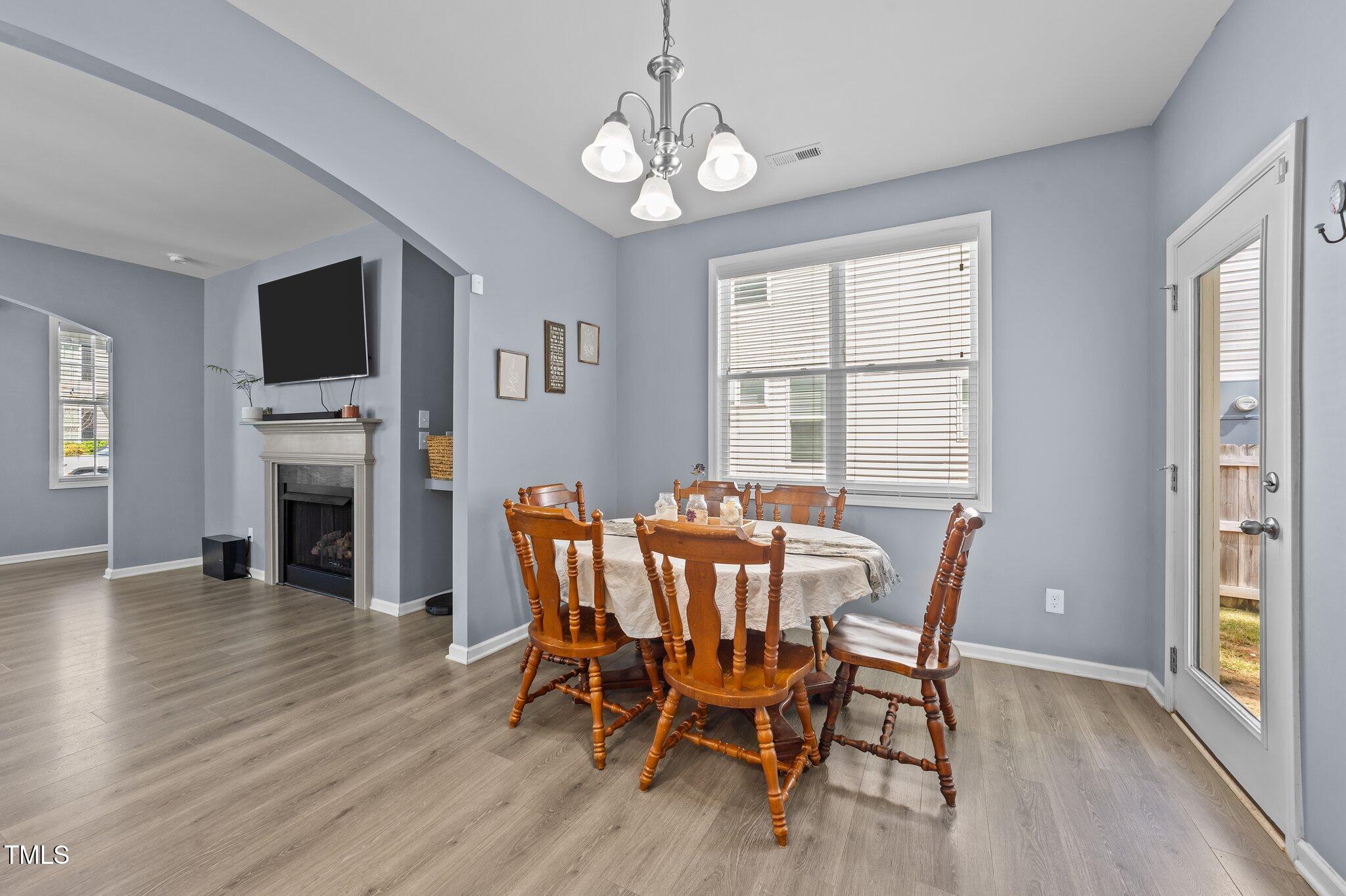 166 Yellow Jacket Ridge Clayton, NC 27520 - Photo 10 of 39 a view of a dining room with furniture window and wooden floor