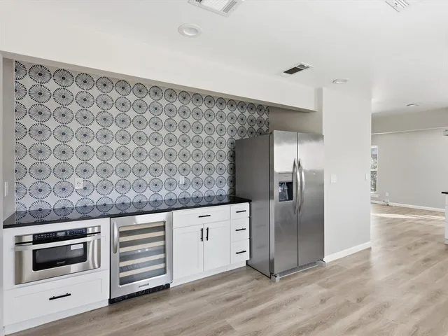 a kitchen with granite countertop a stove and a refrigerator
