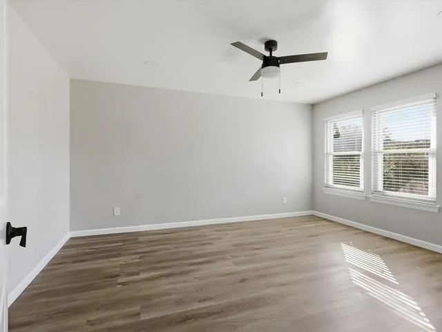 wooden floor in an empty room with a window