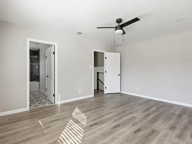 a view of a room with wooden floor and white walls