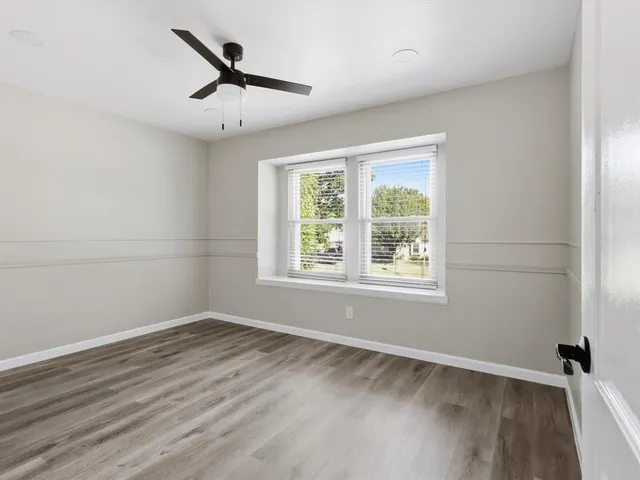wooden floor in an empty room with a window