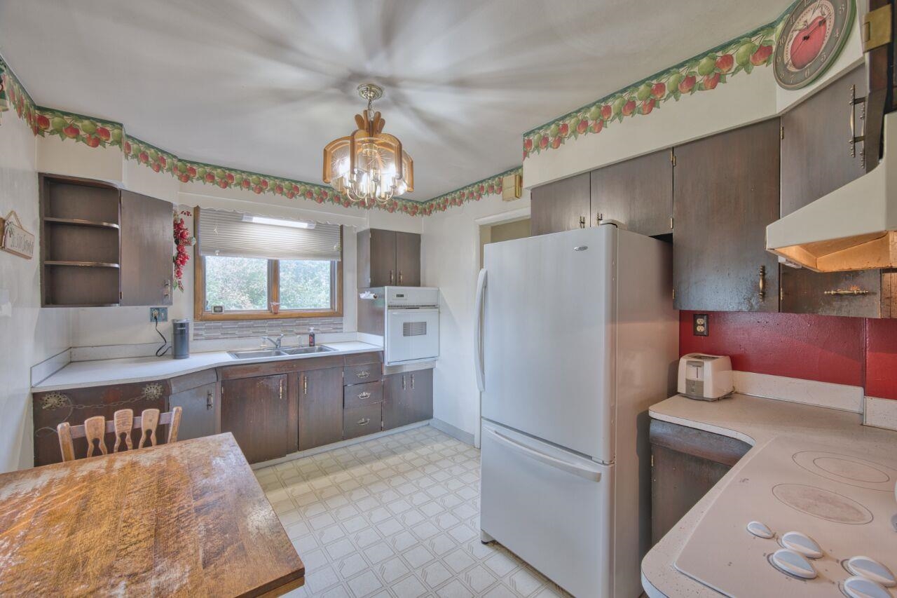 701 Grant Avenue Eveleth, MN 55734 - Photo 15 of 50 Kitchen featuring light floors, white appliances, open shelves, and light countertops