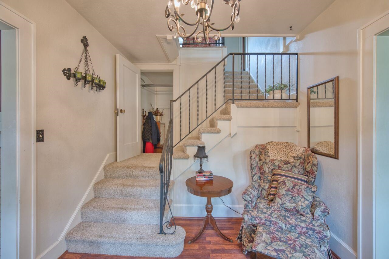 701 Grant Avenue Eveleth, MN 55734 - Photo 18 of 50 Staircase featuring wood finished floors and a chandelier