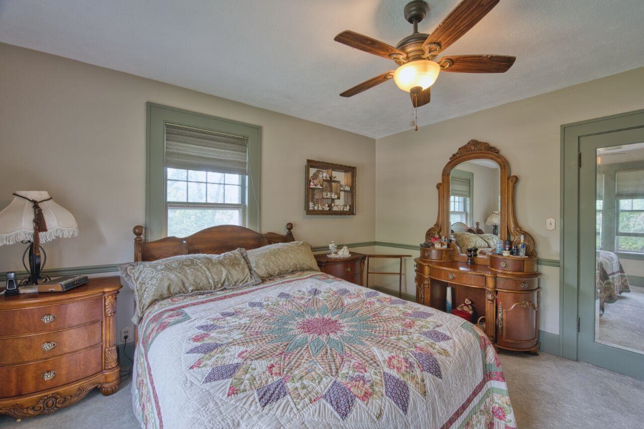 701 Grant Avenue Eveleth, MN 55734 - Photo 21 of 50 Carpeted bedroom featuring multiple windows and ceiling fan