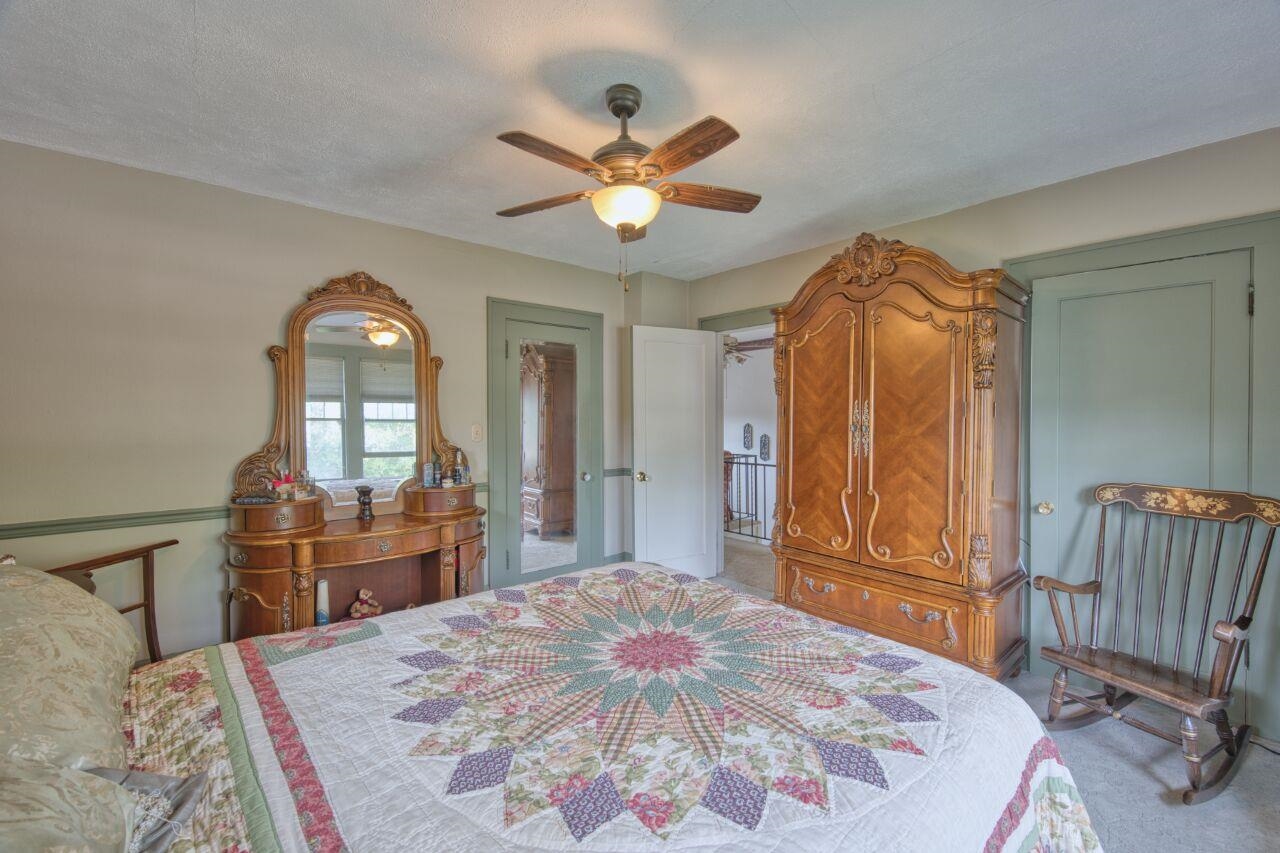 701 Grant Avenue Eveleth, MN 55734 - Photo 23 of 50 Bedroom with carpet flooring, ceiling fan, and a textured ceiling