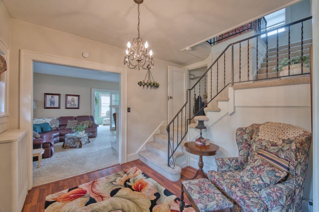 701 Grant Avenue Eveleth, MN 55734 - Photo 3 of 50 Stairs featuring wood finished floors and a chandelier