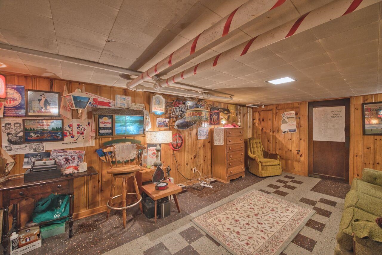 701 Grant Avenue Eveleth, MN 55734 - Photo 35 of 50 Finished below grade area with wood walls and tile patterned floors