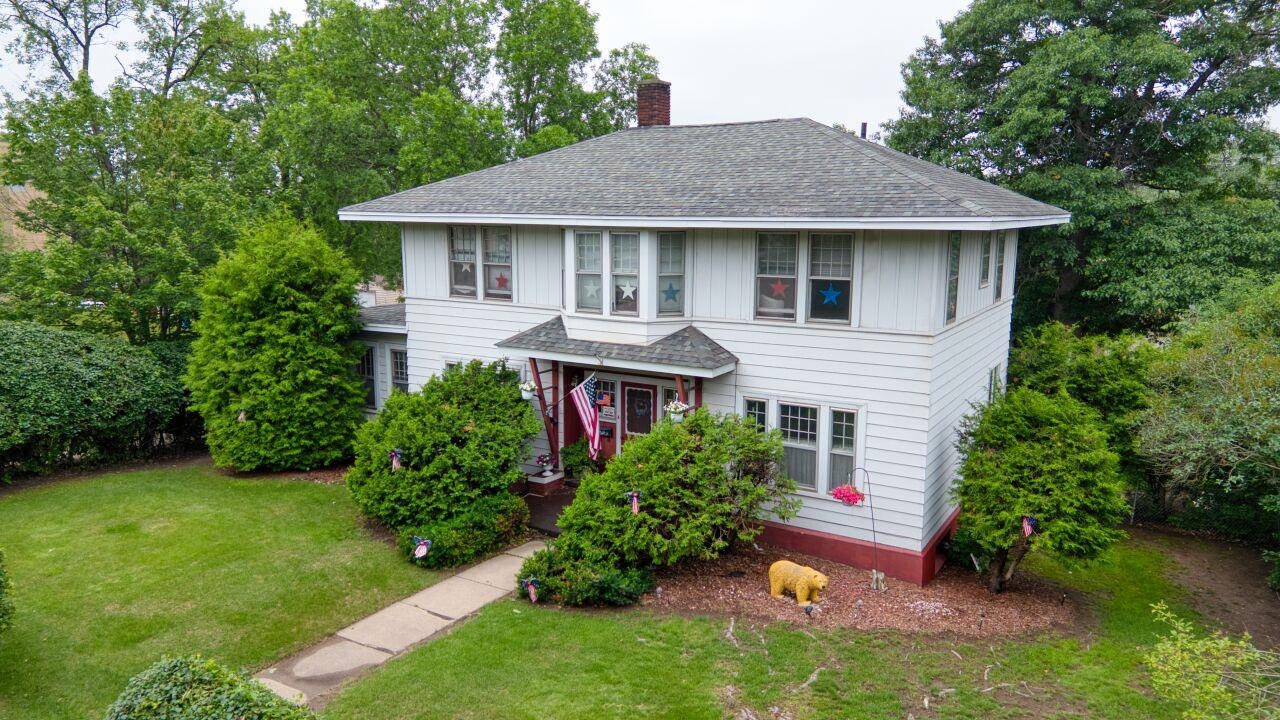701 Grant Avenue Eveleth, MN 55734 - Photo 50 of 50 View of front of property featuring roof with shingles, a front lawn, and a chimney