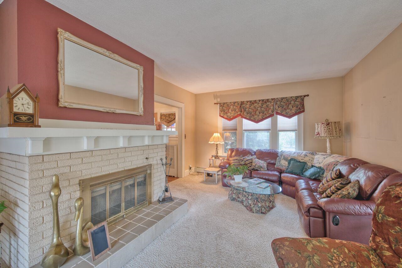 701 Grant Avenue Eveleth, MN 55734 - Photo 5 of 50 Living area featuring carpet floors and a brick fireplace