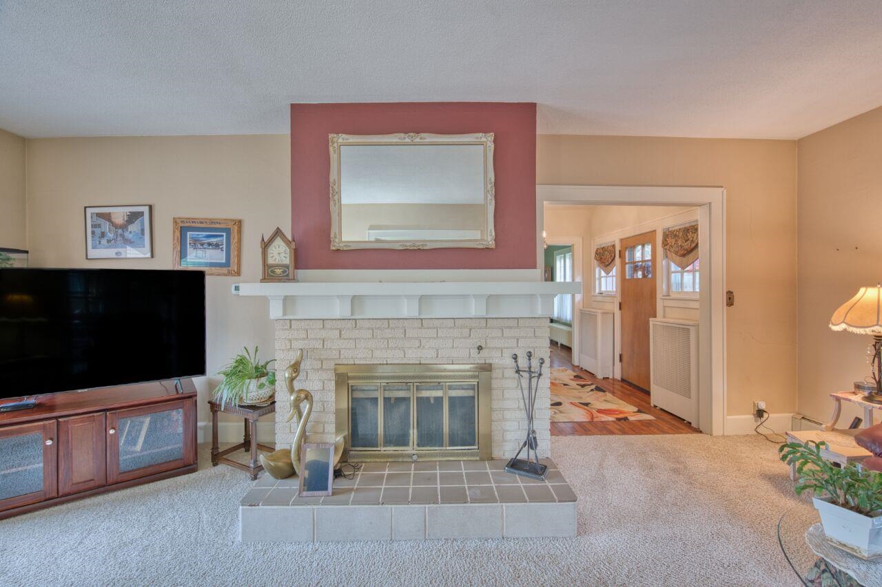 701 Grant Avenue Eveleth, MN 55734 - Photo 6 of 50 Living area featuring carpet flooring and a fireplace