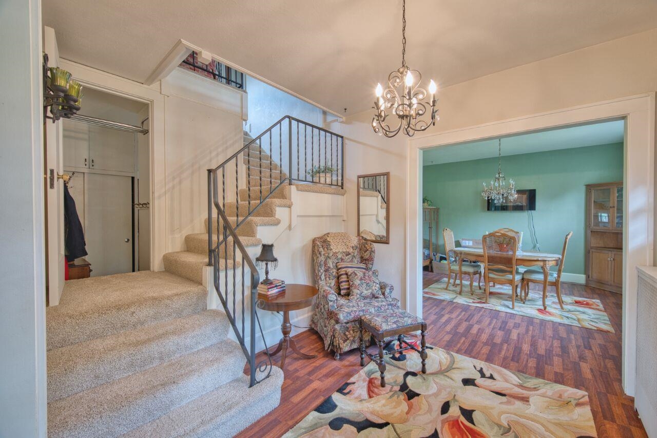701 Grant Avenue Eveleth, MN 55734 - Photo 10 of 50 Living area with stairs, a chandelier, and dark wood-style floors