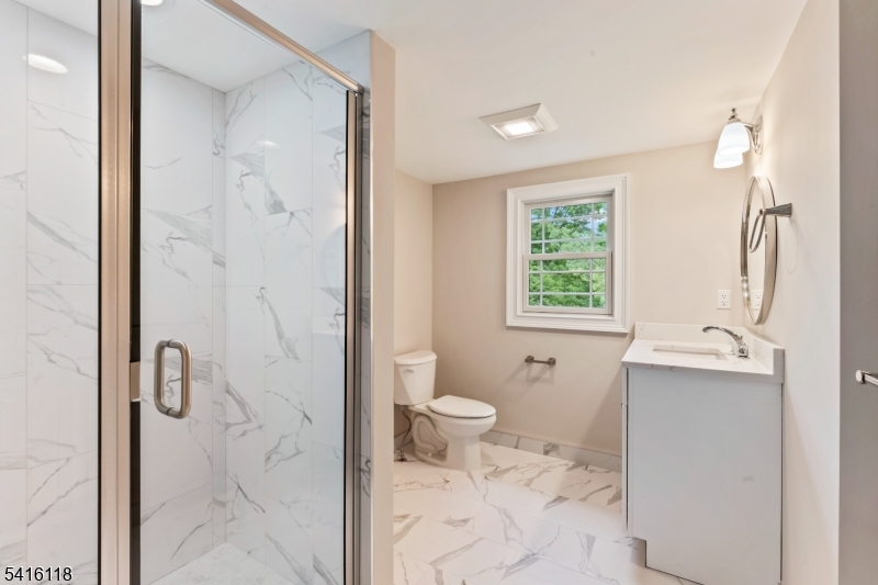 118 Cambridge Road Westfield, NJ 07090 - Photo 39 of 50 a bathroom with a granite countertop sink a toilet and shower
