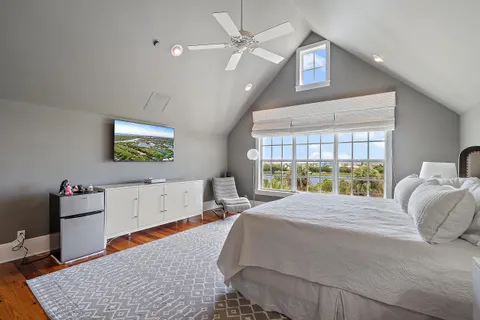 a bedroom with a bed and a chandelier